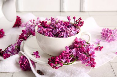 Işık masasının üzerinde güzel leylak çiçekleri olan kompozisyon