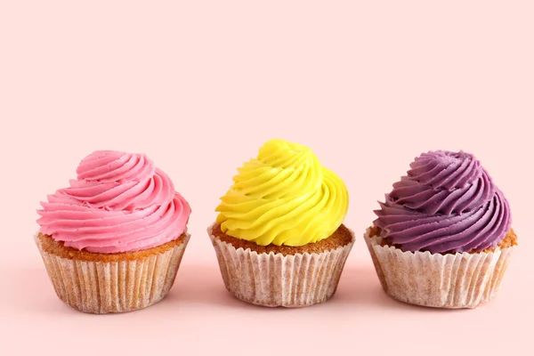 stock image Tasty colorful cupcakes on pink background