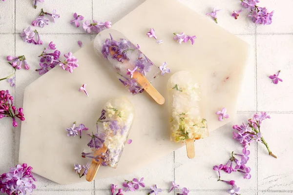 Board Beautiful Floral Popsicles Lilac Flowers Light Tile Background — Stock Photo, Image
