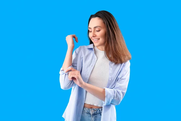 Beautiful Young Woman Rolling Her Sleeve Light Blue Background — Stock Photo, Image