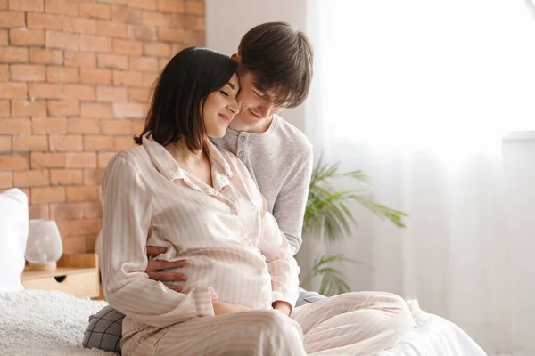 Young Pregnant Couple Sitting Bedroom — Stock Photo, Image