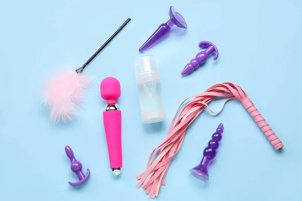 stock image Bottle of lubricant and sex toys on blue background