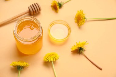 Kavanoz ve turuncu arka planda ballı karahindiba.