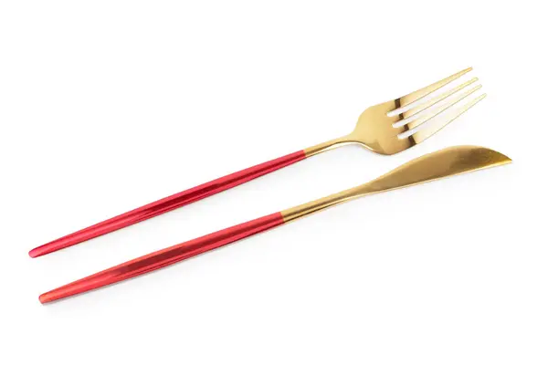 Beyaz Arka Planda Kırmızı Saplı Altın Çatal Bıçak — Stok fotoğraf