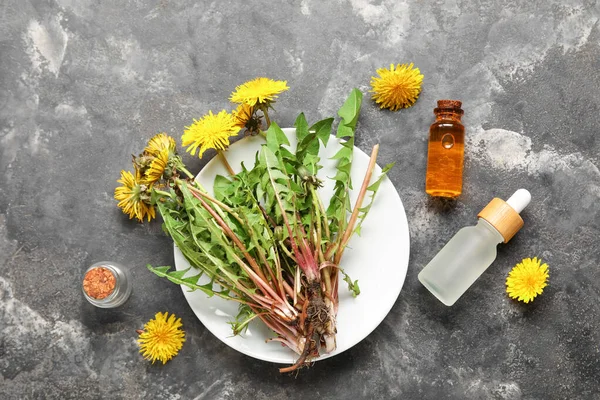 Bottles Cosmetic Oil Plate Dandelion Flowers Grey Background — Stock Photo, Image
