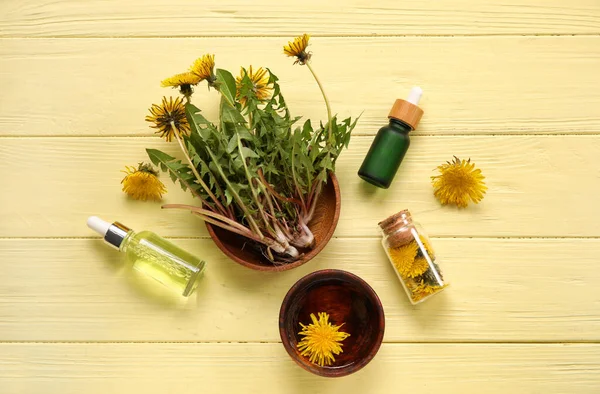 Bottles Cosmetic Oil Bowls Dandelion Flowers Yellow Wooden Background — Stock Photo, Image