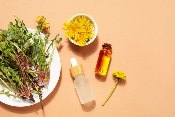 Bottles Cosmetic Oil Plate Dandelion Flowers Orange Background — Stock Photo, Image