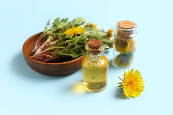 Bottles Cosmetic Oil Bowl Dandelion Flowers Blue Background — Stock Photo, Image