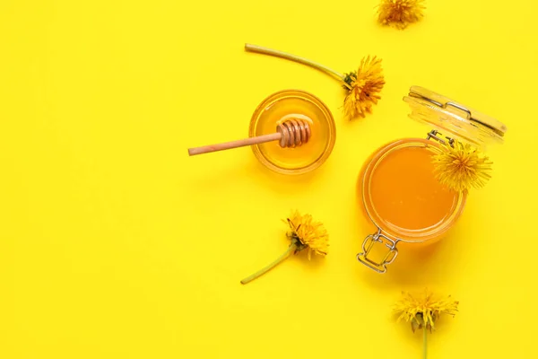 stock image Jar and bowl with dandelion honey on yellow background