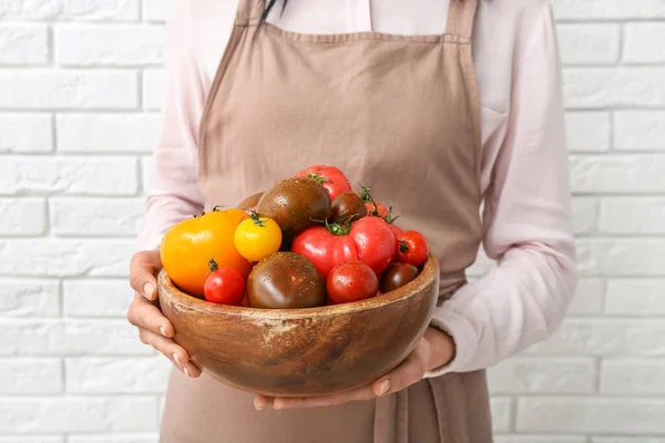 Woman Holding Wooden Bowl Different Fresh Tomatoes White Brick Background — Stock Photo, Image