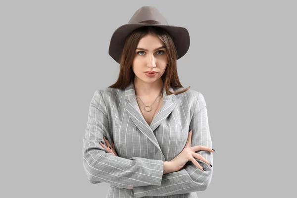 Stylish Young Woman Jacket Hat Grey Background — Stockfoto