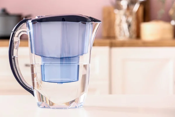 stock image Modern filter jug on table in kitchen