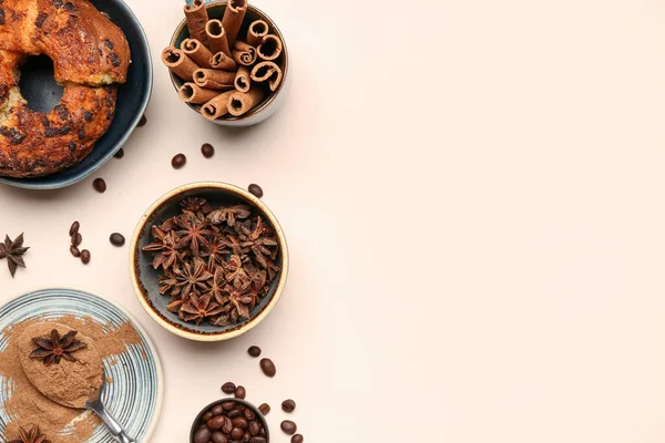 Composition with cinnamon sticks, powder, coffee beans, anise stars and cake on light background