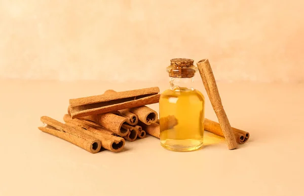 Bottle Essential Oil Cinnamon Sticks Color Background — Stock Photo, Image