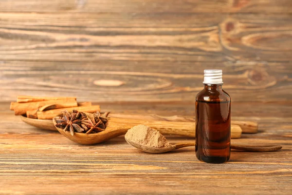 Bottle Essential Oil Spoons Cinnamon Powder Sticks Anise Stars Wooden — Stock Photo, Image