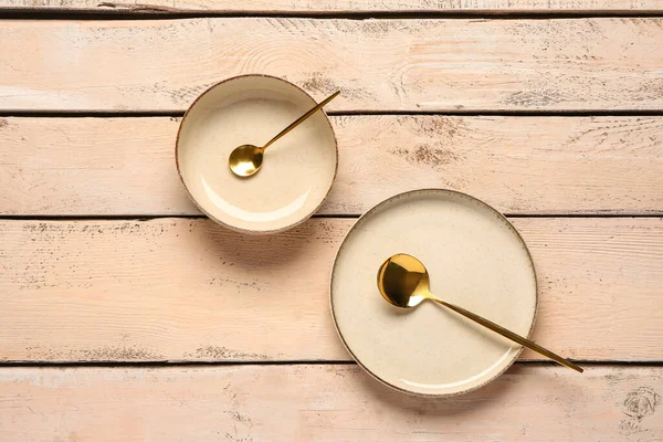 stock image Table setting with clean plate, bowl and spoon on beige wooden table