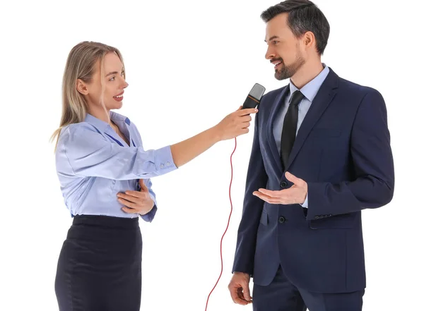 stock image Female journalist with microphone having an interview with businessman on white background