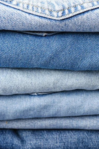 Different Folded Denim Jeans Background Closeup — Stock Photo, Image