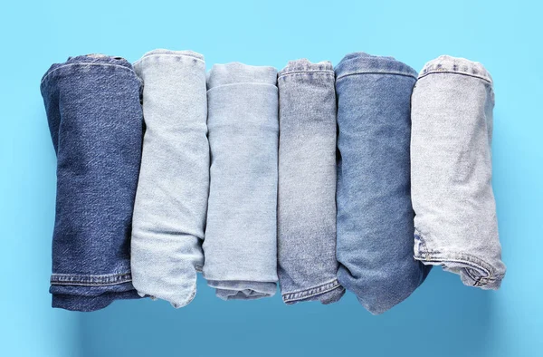 Different Folded Jeans Blue Background — Stock Photo, Image
