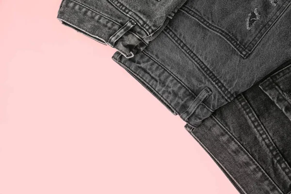 Different Folded Dark Jeans Pink Background — Stock Photo, Image