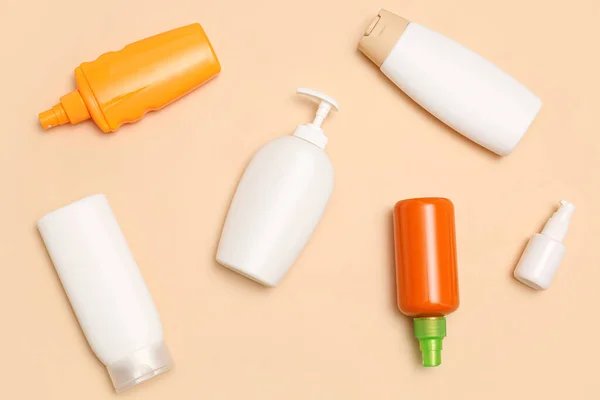 Different Bottles Sunscreen Cream Pale Orange Background — Stock Photo, Image