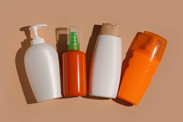 Different Bottles Sunscreen Cream Brown Background — Stock Photo, Image