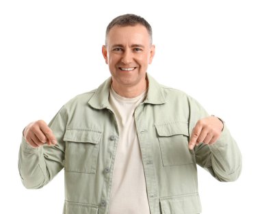 Olgun adam beyaz arka plandaki bir şeyi işaret ediyor.