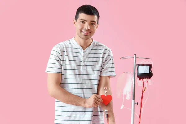 Junger Mann Mit Papierherz Spendet Blut Auf Rosa Hintergrund — Stockfoto