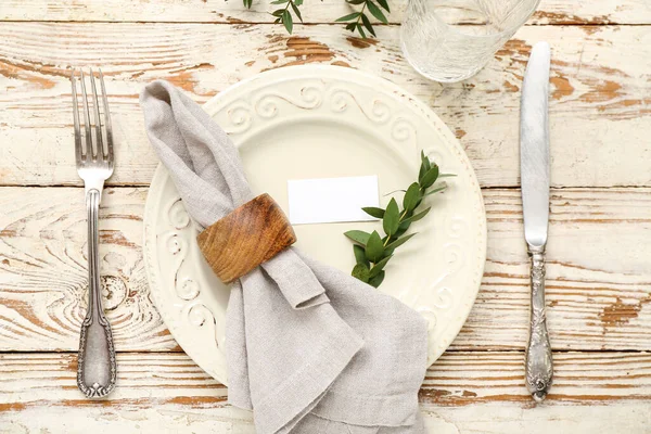 stock image Stylish table setting with blank card and glass on light wooden background