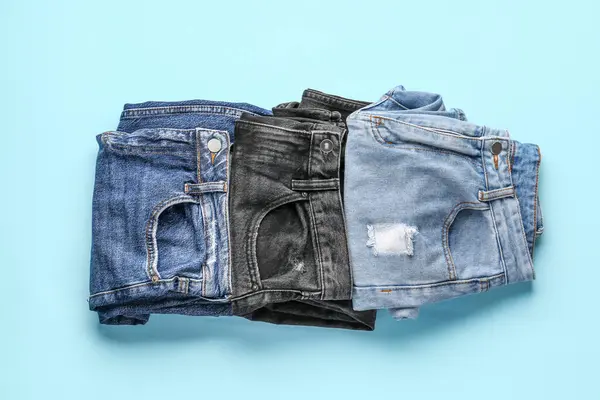 Different Folded Jeans Blue Background — Stock Photo, Image