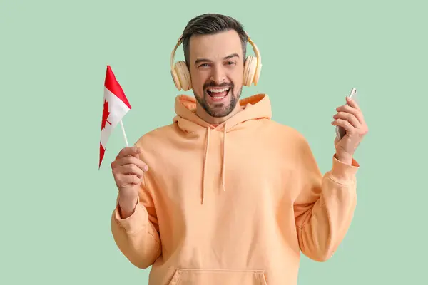 Hombre Guapo Auriculares Con Bandera Canadá Teléfono Móvil Sobre Fondo —  Fotos de Stock