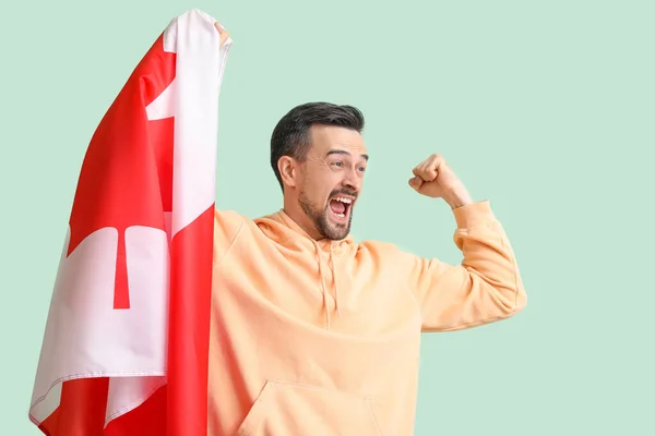 快乐的年轻人 绿色背景 拿着加拿大国旗 — 图库照片