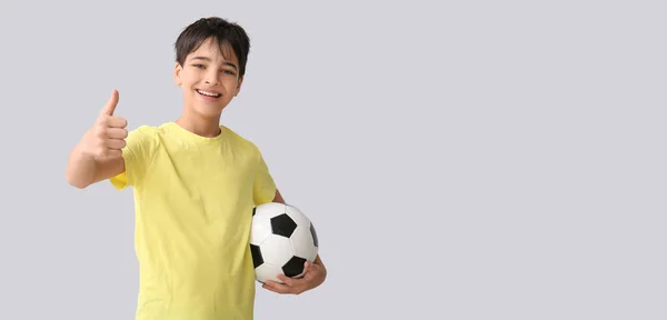 Malý Chlapec Fotbalovým Míčkem Ukazující Palec Nahoru Šedém Pozadí Prostorem — Stock fotografie