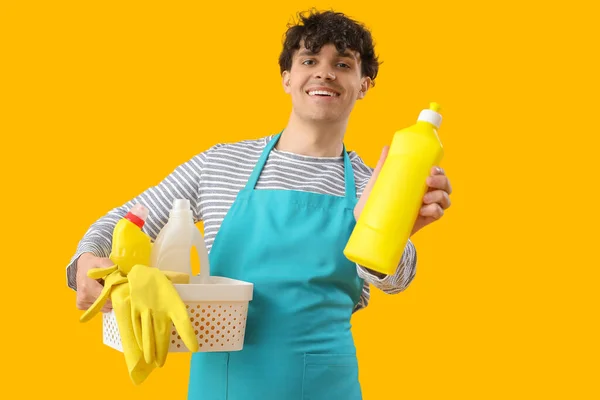 Young Man Basket Cleaning Supplies Yellow Background — Stock Photo, Image