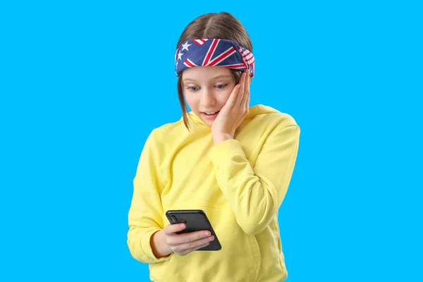 Surprised Little Girl Using Mobile Phone Blue Background — Stock Photo, Image