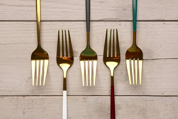 Golden Forks Colored Handles Grey Wooden Background — Stock Photo, Image