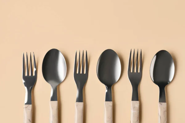 Stainless Steel Forks Spoons Plastic Handles Beige Background — Stock Photo, Image