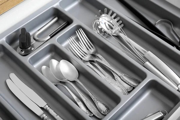 stock image Open kitchen drawer with different silver cutlery