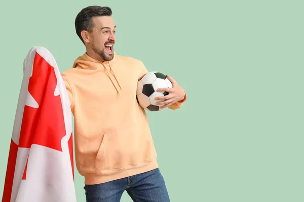 Schöner Mann Mit Kanadischer Flagge Und Fußball Auf Grünem Hintergrund — Stockfoto