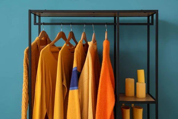 Shelving Unit Clothes Candles Blue Wall — Stock Photo, Image