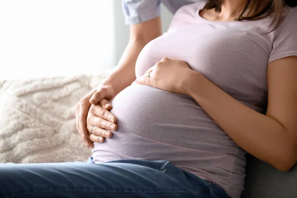 Young Pregnant Woman Her Husband Sitting Sofa Home Closeup — Stock Photo, Image