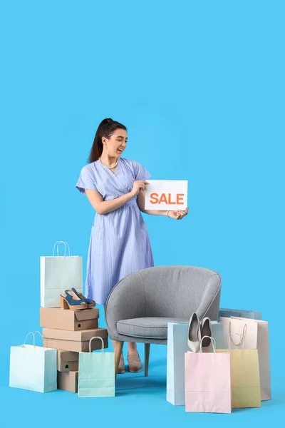 Female Seller Sale Sign Shoe Boxes Shopping Bags Armchair Blue — Stock Photo, Image