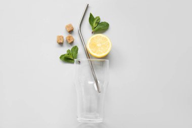 Limonlu bardak ve gri arka planda nane şekeri.