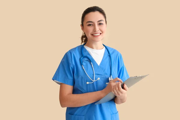 Female Medical Assistant Clipboard Beige Background — Fotografia de Stock
