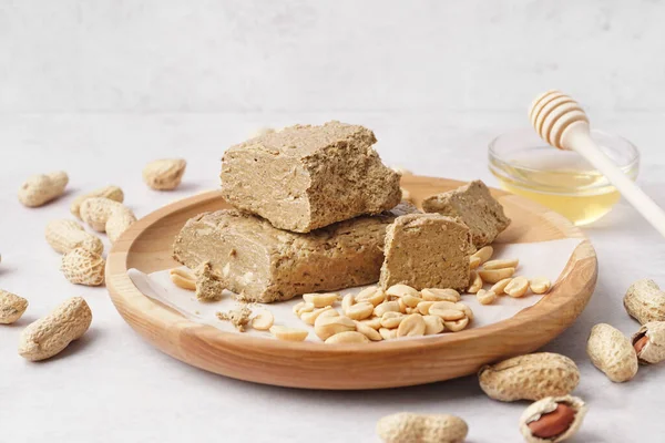 Wooden Plate Pieces Tasty Halva Peanuts White Background — Stock Photo, Image