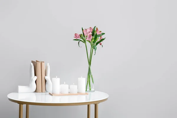 Burning Candles Vase Alstroemeria Flowers Books Table Grey Wall — Stock Photo, Image
