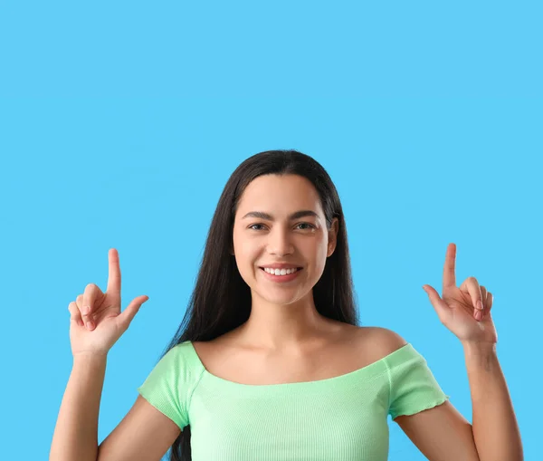 Beautiful Young Woman Pointing Something Blue Background Closeup — Stock Photo, Image