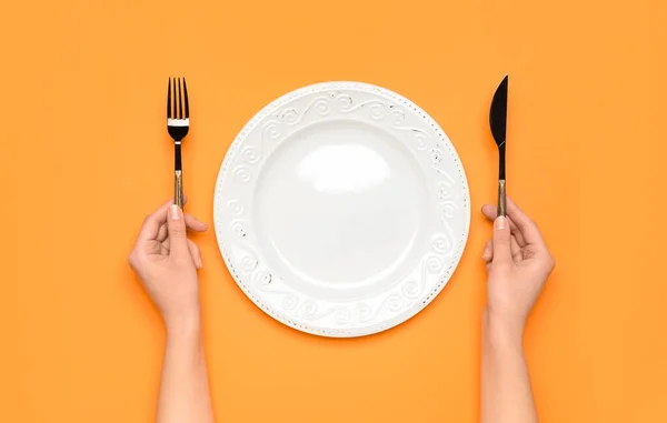 Female Hands Empty Plate Cutlery Orange Background — Stock Photo, Image