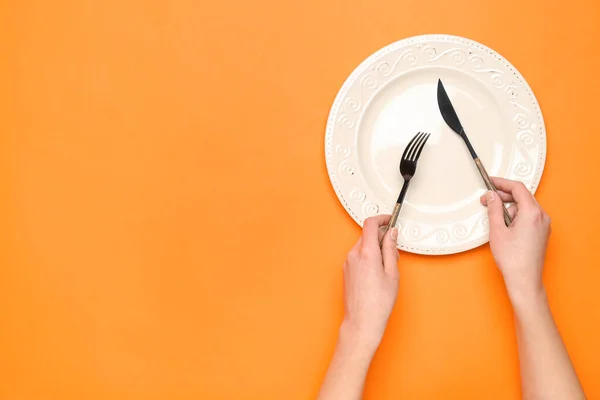 Female Hands Empty Plate Cutlery Orange Background — Stock Photo, Image