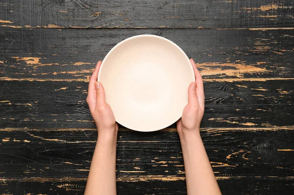 Female Hands Empty Plate Black Wooden Background — Stock Photo, Image